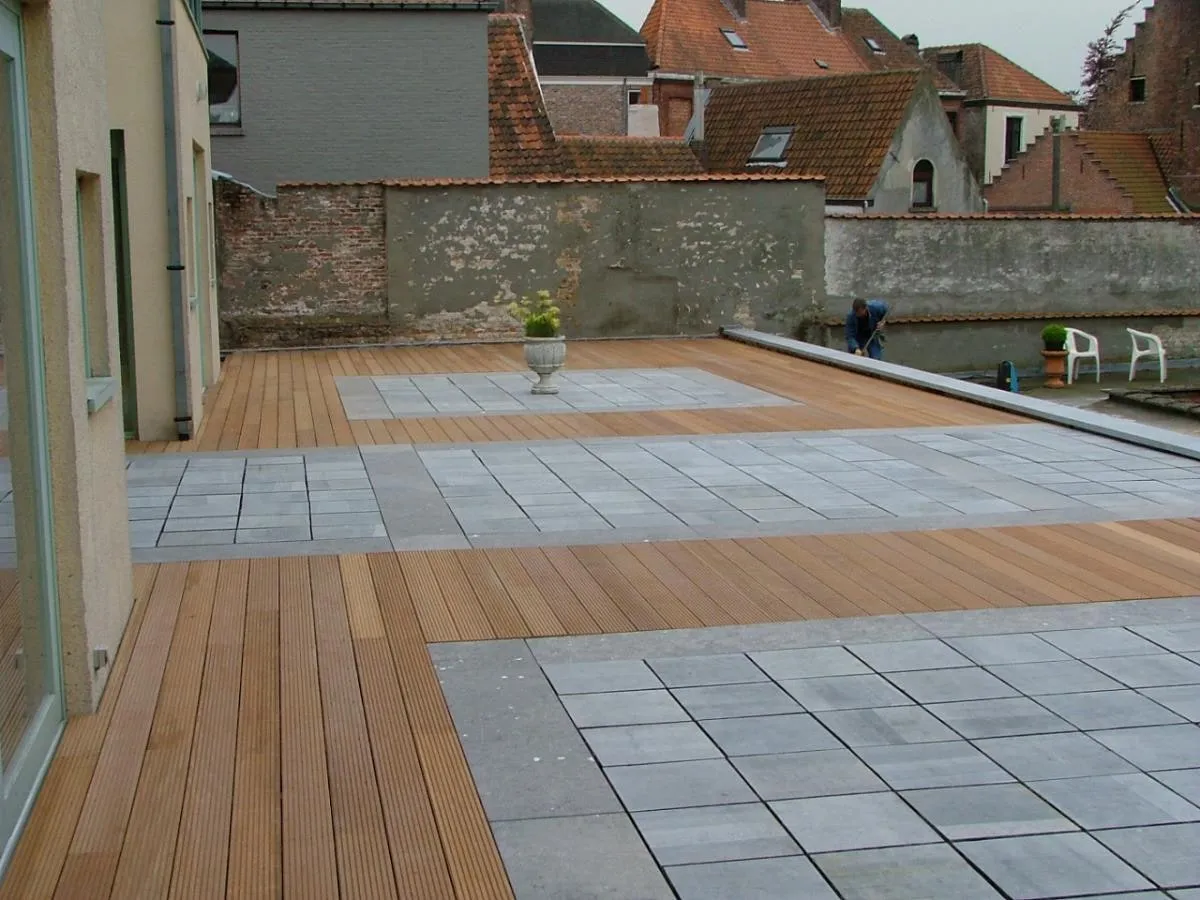 Ruim terras waarin houten planken en grijze tegels elkaar afwisselen